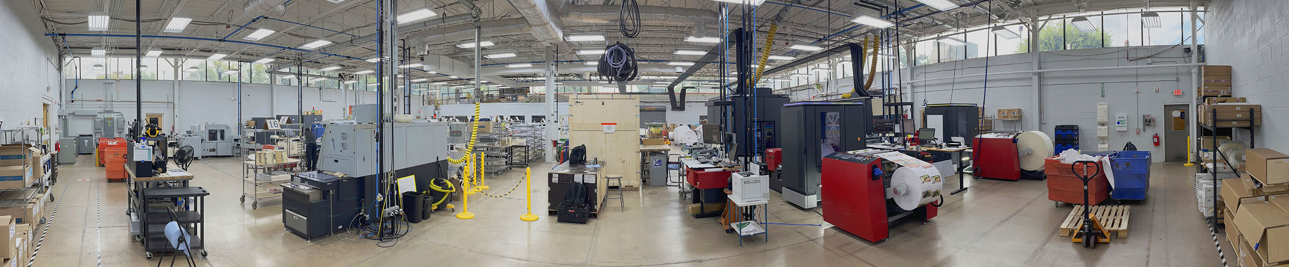 Close-up of a G7 Master Certified printing press producing colorful book covers at BookBaby's printing facility.