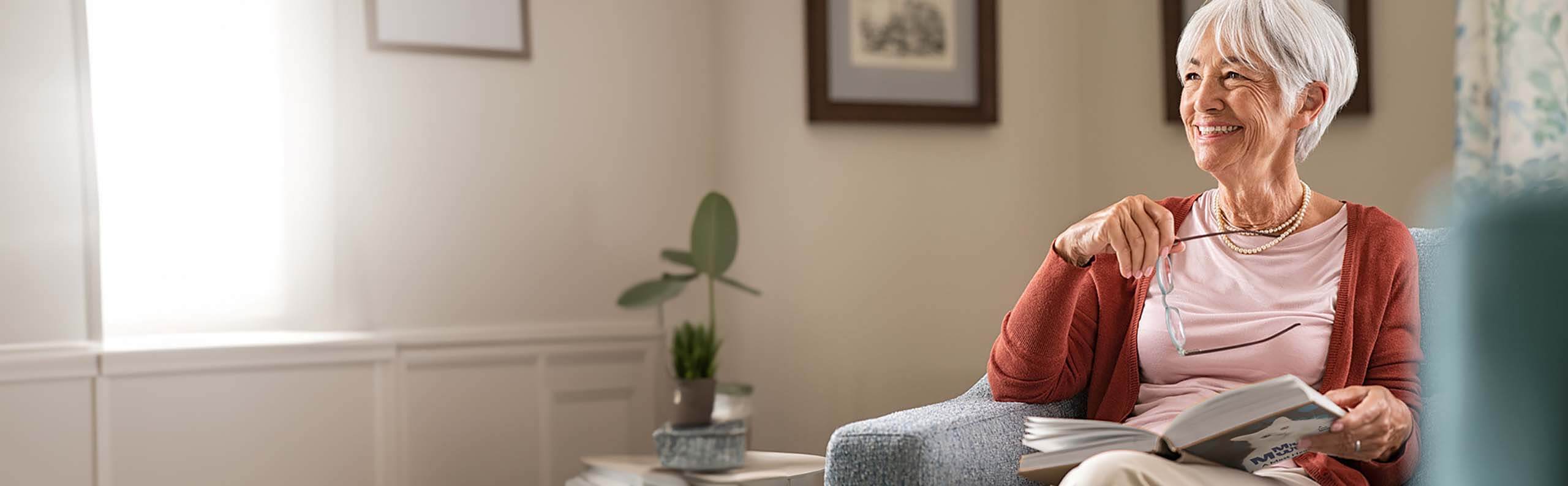 An older woman reading a biography book
